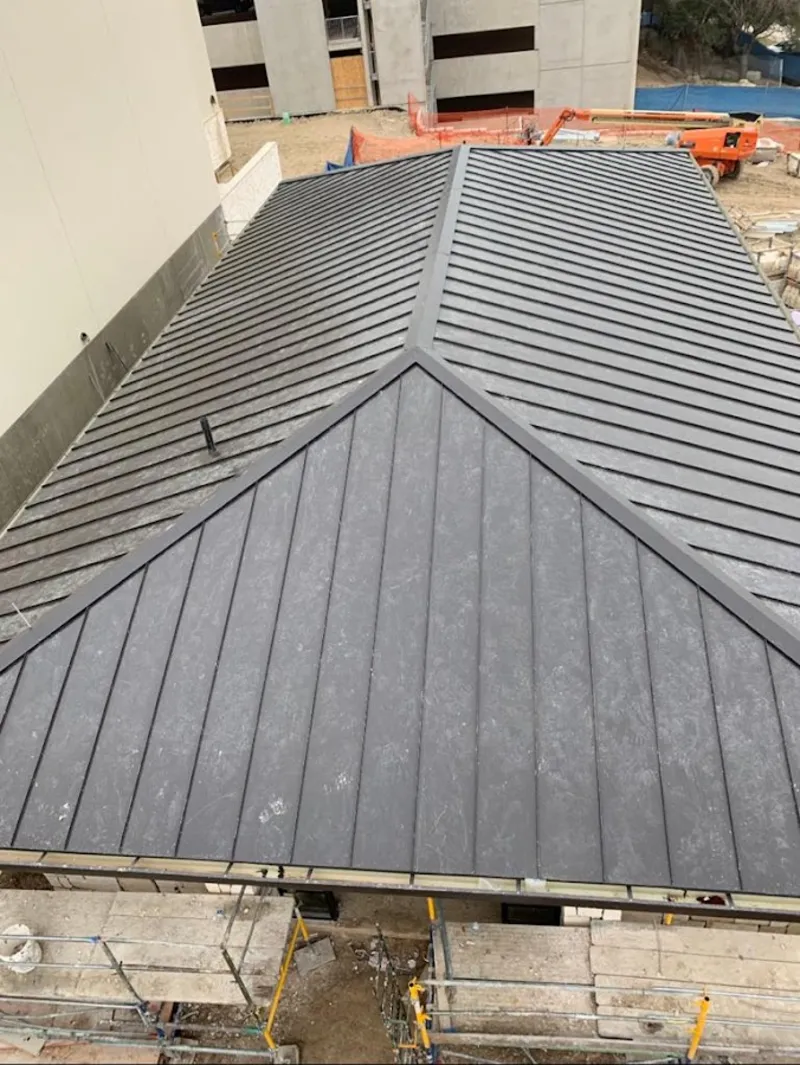 Commercial metal roof construction with crane equipment in Lorain